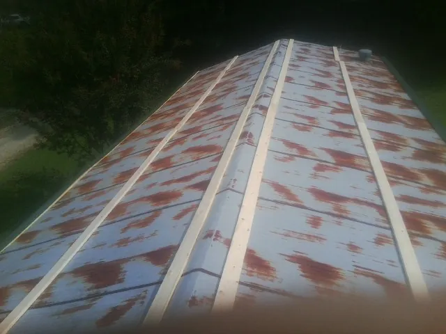 Rusted metal roof panels with new wood purlins before replacement — Storm Damage Roof Repair in Fishers by Roofing Brothers